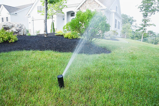 Technician connecting irrigation pipes for sprinkler system installation