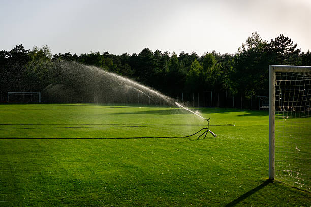 Technician programming irrigation controller at Ocean Pines, MD residence for seasonal watering needs