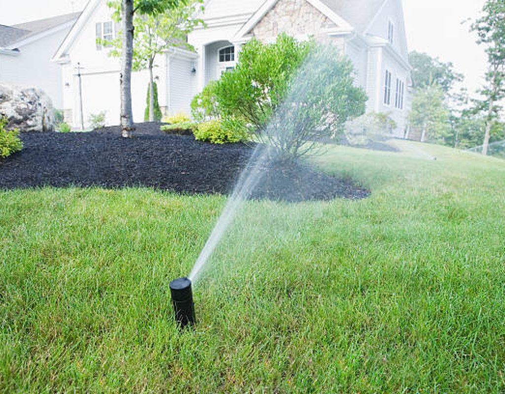 Technician connecting irrigation pipes for sprinkler system installation