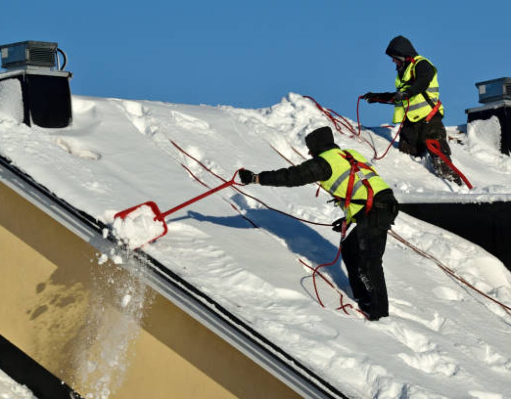 professional technicians clearing driveways after overnight snow for improved mobility