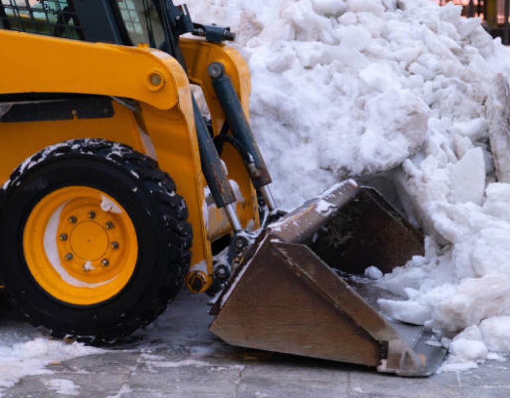 trained crew removing heavy snow buildup around homes and businesses today