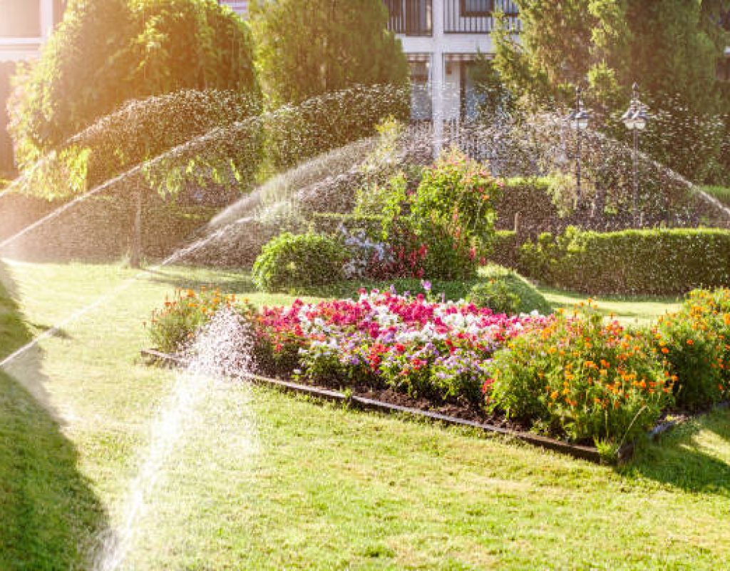 Technician adjusting irrigation system on suburban Grasonville, MD residential property