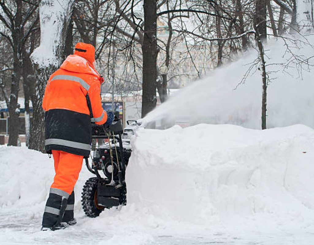 reliable crew performing detailed snow removal around steps and entryways