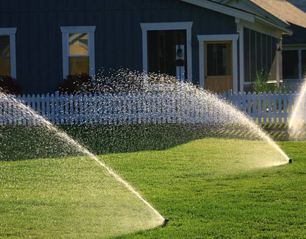 Irrigation specialist setting up automated sprinkler system controller