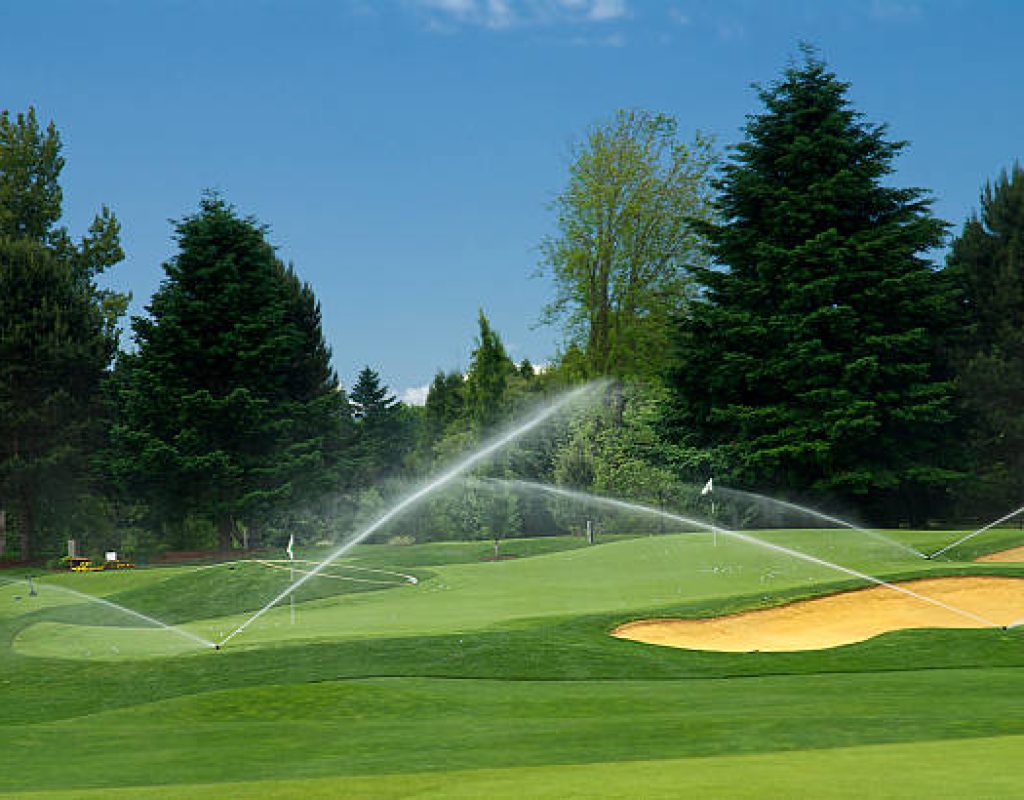 Irrigation expert checking sprinkler pressure during repair