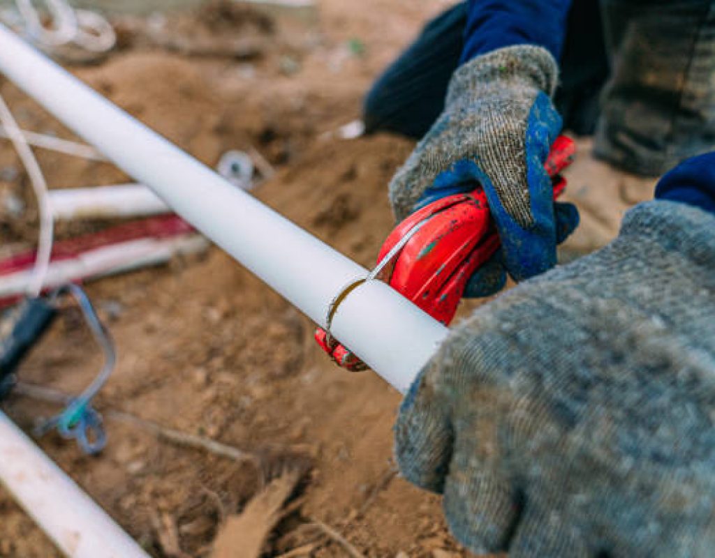 Miles Creek Irrigation technician repairing underground sprinkler line