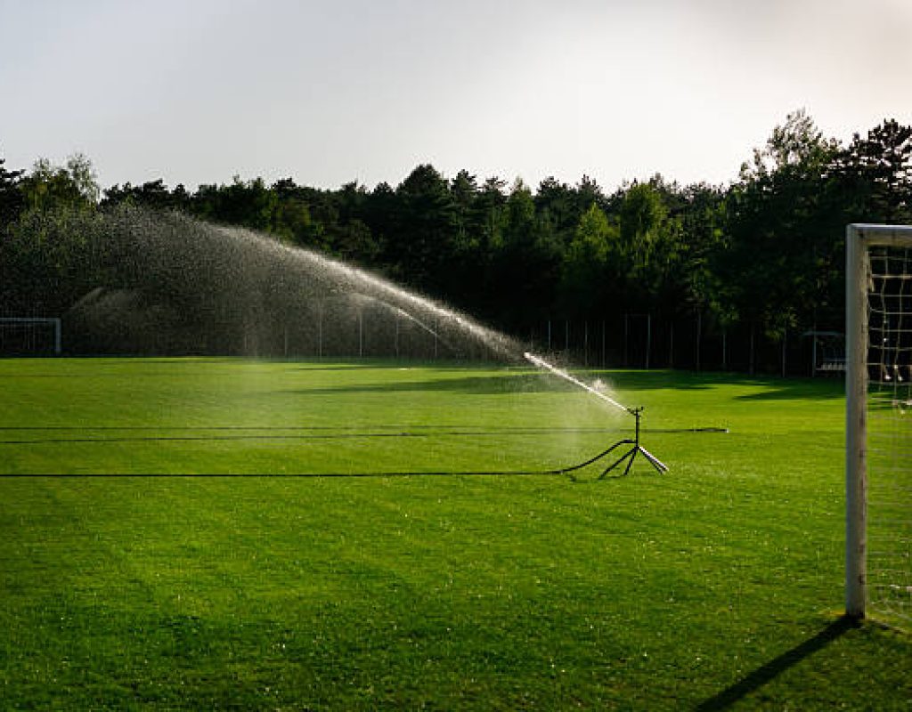 Technician programming irrigation controller at Ocean Pines, MD residence for seasonal watering needs