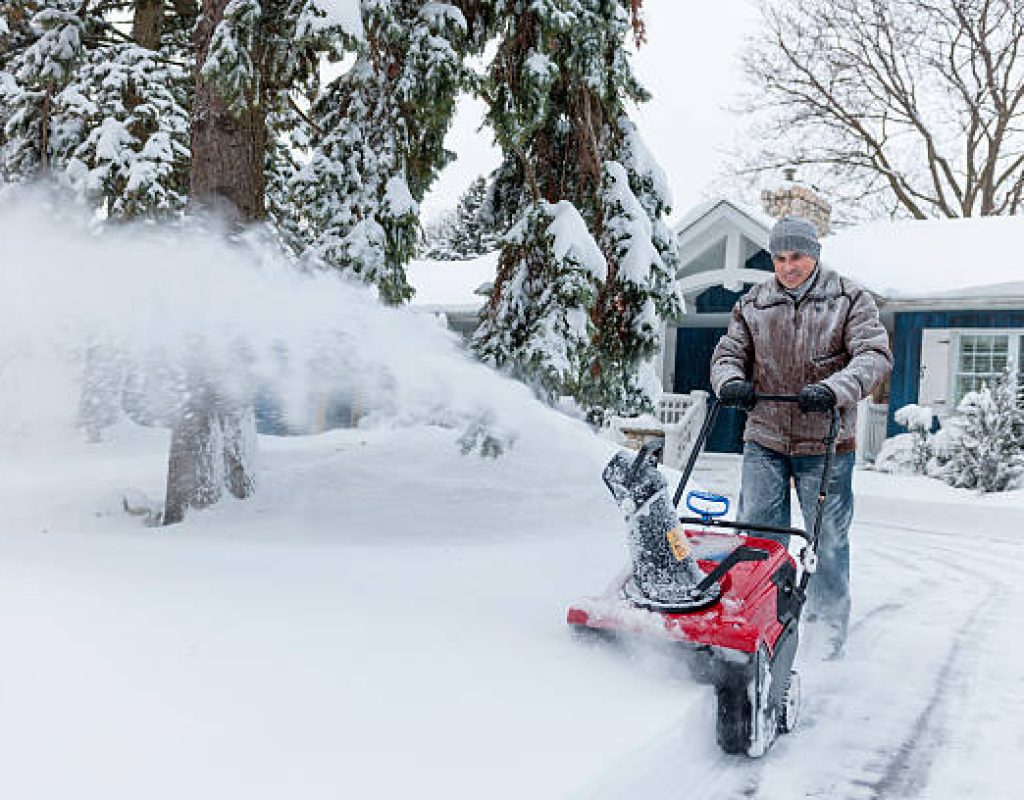 commercial snow removal professionals clearing parking lots for safer customer access